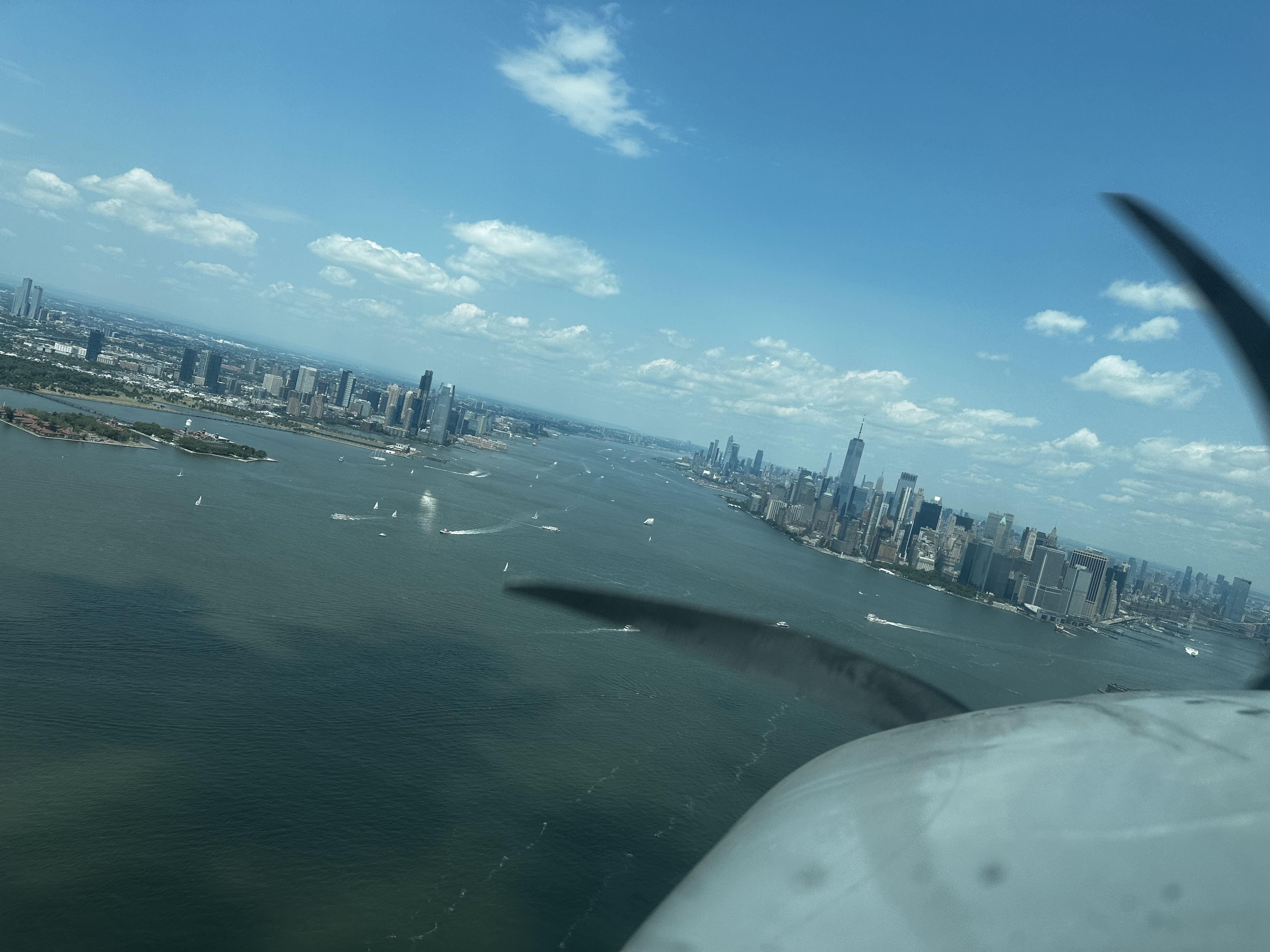 Hudson River and Lower Manhattan, spinner and cowling in the foreground