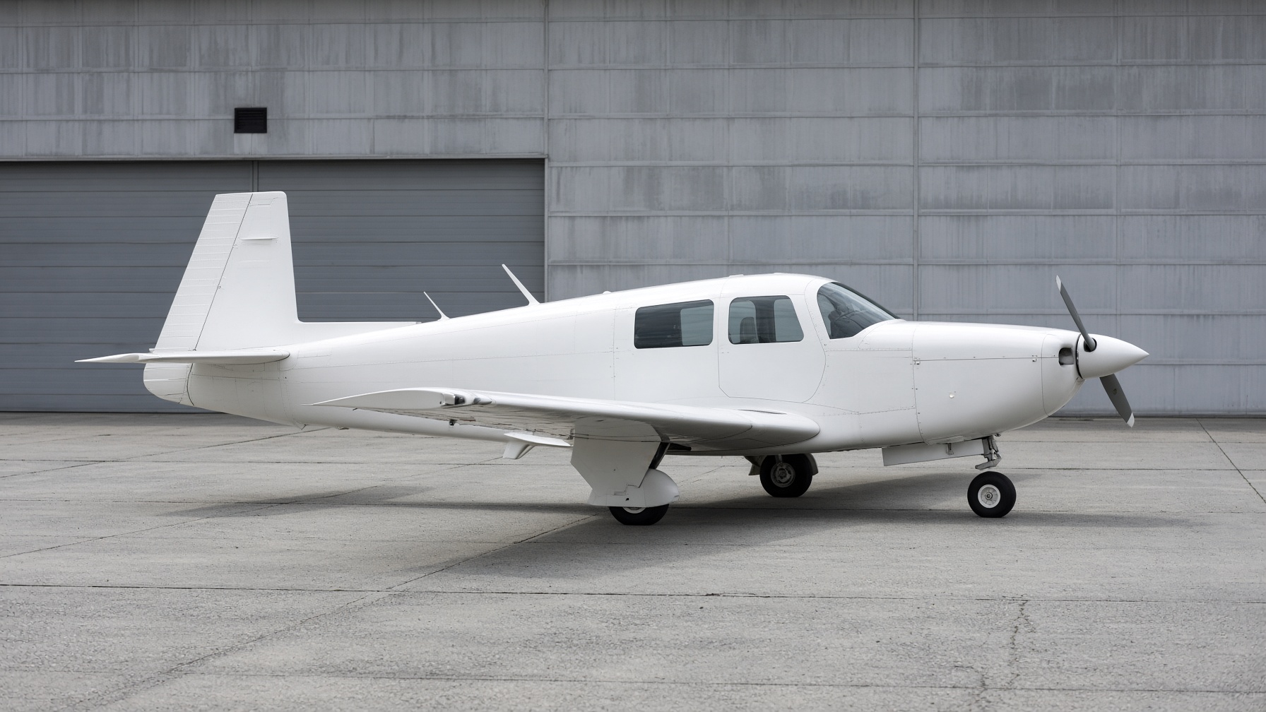 Left side of a white Mooney M20, mirrored from the right-side photo, nose pointing left